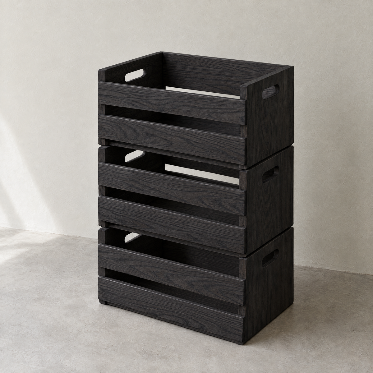 Three stacked sorting crates in black-stained ash