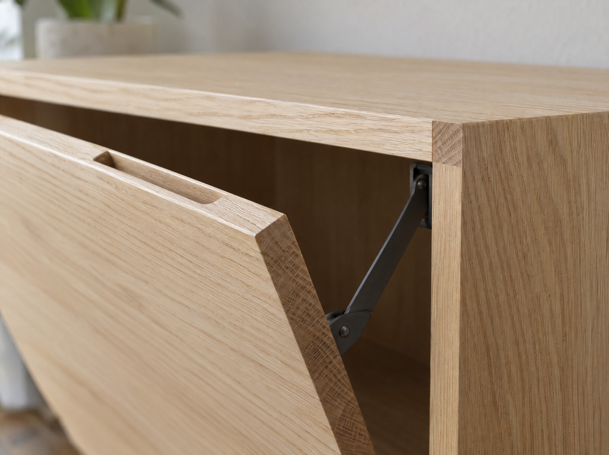 Close-up of a tilt-out door edge with its finger-pull slot and folding stay